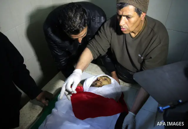 Palestinians prepare the body of Mustafa Tamimi prior to his funeral at a hospital in the West Bank city of Ramallah, Sunday, Dec. 11, 2011. Tamini, 28, was hurling rocks at an Israeli military vehicle on Friday in the W...
