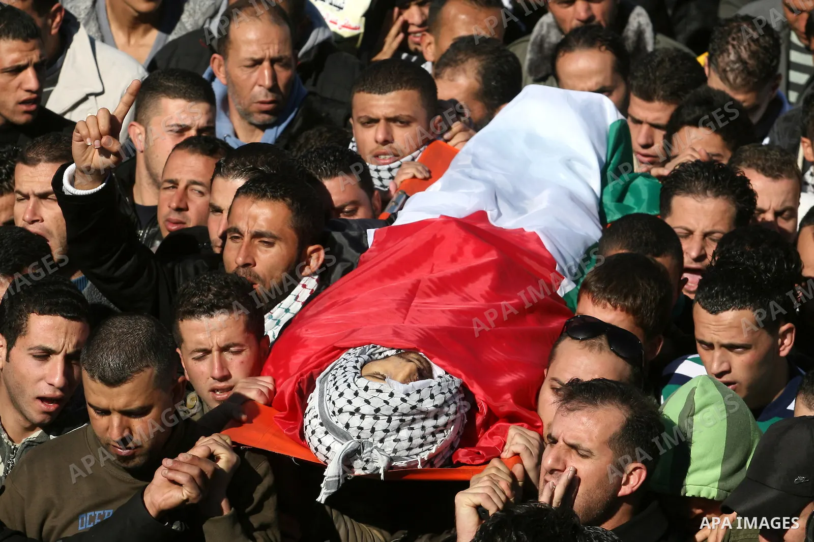 Palestinians carry the body of Mustafa Tamimi during his funeral in the West Bank city of Ramallah, Sunday, Dec. 11, 2011. Tamini, 28, was hurling rocks at an Israeli military vehicle on Friday in the West Bank village o...
