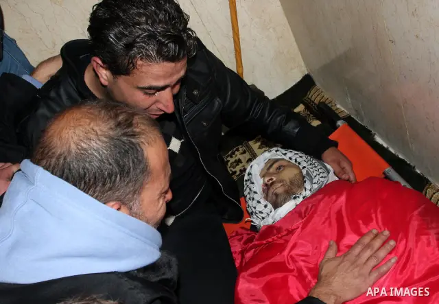 Relatives mourn during the funeral of Palestinian activist Mustafa al-Tamimi in the West Bank village of Nabi Saleh on December 11, 2011. Tamimi, 28, was hurling rocks at an Israeli military vehicle on Friday in the West...