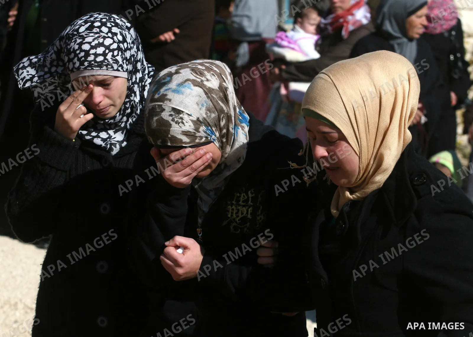 Relatives mourn during the funeral of Palestinian activist Mustafa al-Tamimi in the West Bank village of Nabi Saleh on December 11, 2011. Tamini, 28, was hurling rocks at an Israeli military vehicle on Friday in the West...