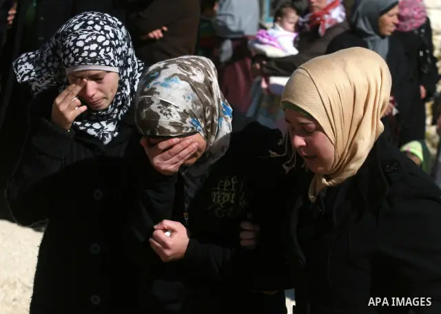 Relatives mourn during the funeral of Palestinian activist Mustafa al-Tamimi in the West Bank village of Nabi Saleh on December 11, 2011. Tamini, 28, was hurling rocks at an Israeli military vehicle on Friday in the West...