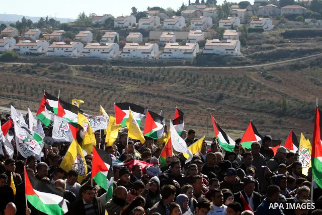 Palestinians carry the body of Mustafa Tamimi during his funeral in the West Bank city of Ramallah, Sunday, Dec. 11, 2011. Tamini, 28, was hurling rocks at an Israeli military vehicle on Friday in the West Bank village o...