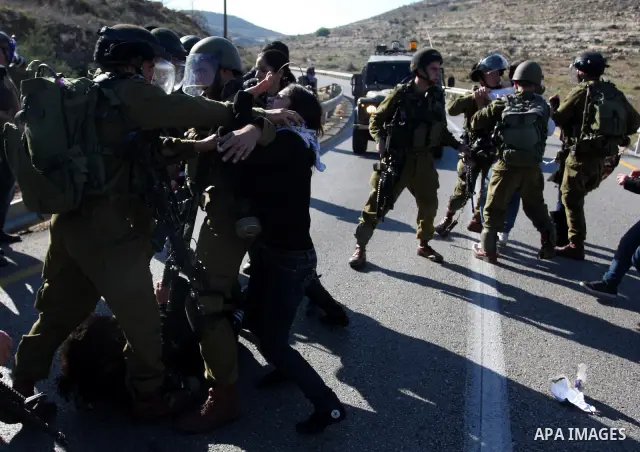 Israeli soldiers detain demonstrators following clashes which erupted after the funeral of Palestinian Mustafa Tamimi in the West Bank town of Nabi Saleh, Sunday, Dec. 11, 2011. Tamimi, 28, was hurling rocks at an Israel...