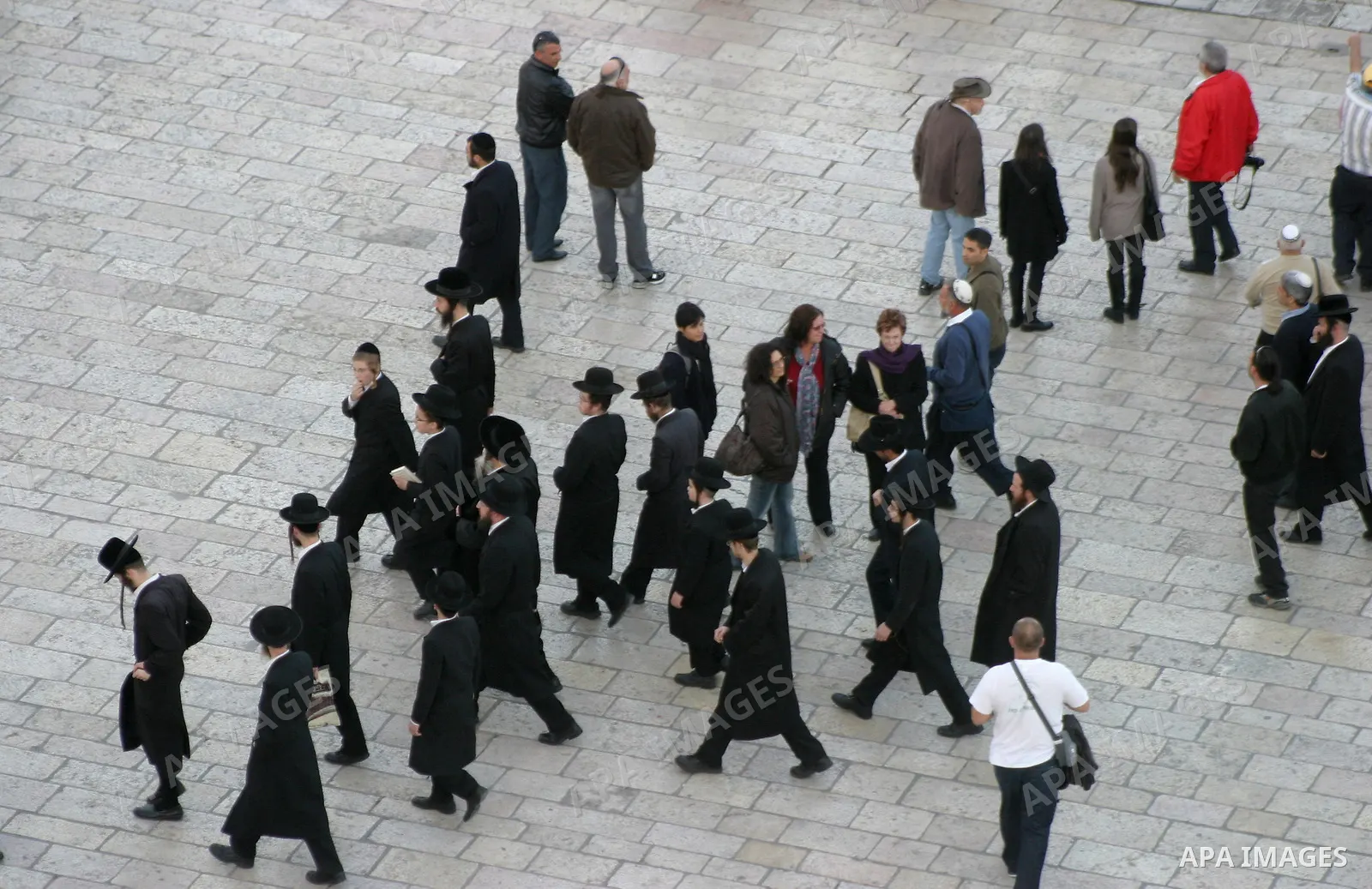 Ultra-Orthodox Jewish men walk at a view-point overlooking a wooden ramp leading up from Judaism's Western Wall to the sacred compound known to Muslims as the Noble Sanctuary and to Jews as Temple Mount, where the al-Aqs...