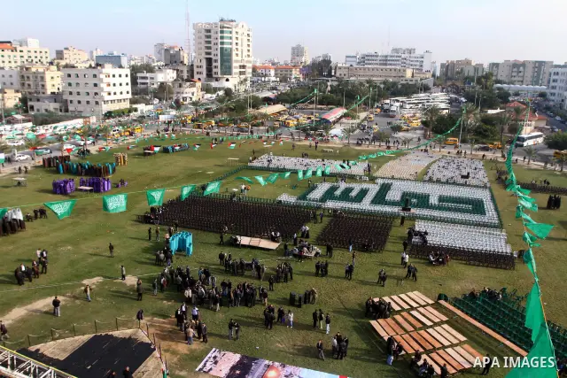 Palestinian members of Hamas prepare the court of "Qatiba" for the celebrations marking the Islamist movement's 24th founding anniversary, in Gaza city on Dec 13,2011. The main celebration will be held on December 14, th...