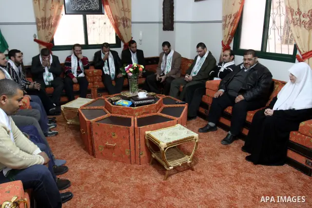 Members of al-Wa'ad team for Nasheed visit the home of Hamas legislator, Mariam Farahat in preparation for the celebrations marking the Islamist movement's 24th anniversary, in Gaza city on Dec. 13,2011. The main celebra...