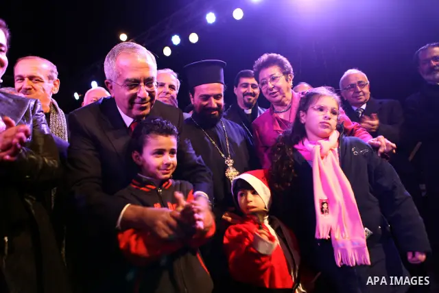 Palestinian Prime Minister, Salam Fayyad, during a ceremony of lighting the Christmas tree, in the West Bank City of Ramallah, On Dec.13, 2011. Photo by Mustafa Abu Dayeh