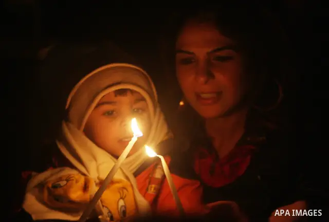 Palestinians Children light candles during a ceremony for lighting the Christmas tree, in the West Bank City of Ramallah, On Dec.13, 2011. Photo by Issam Rimawi