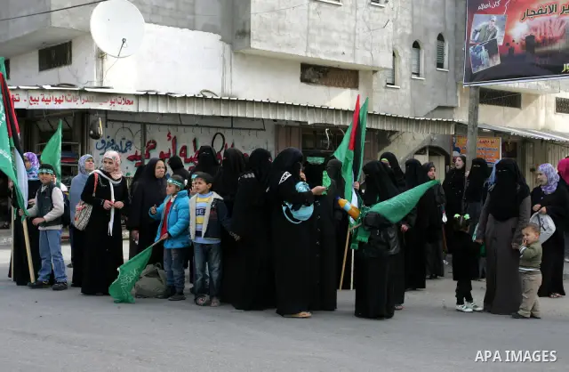 Palestinian Hamas supporters gather in the streets during the celebrations marking the Islamist movement's 24th founding anniversary, in the Rafah refugee camp in the southern Gaza Strip on December 14, 2011. Photo by Ab...