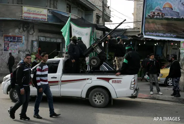 Palestinian Hamas militants patrol in the streets during the celebrations marking the Islamist movement's 24th founding anniversary, in the Rafah refugee camp in the southern Gaza Strip on December 14, 2011. Photo by Abe...
