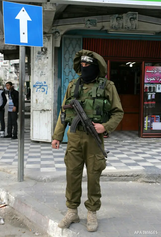 Palestinian Hamas militants patrol in the streets during the celebrations marking the Islamist movement's 24th founding anniversary, in the Rafah refugee camp in the southern Gaza Strip on December 14, 2011. Photo by Abe...