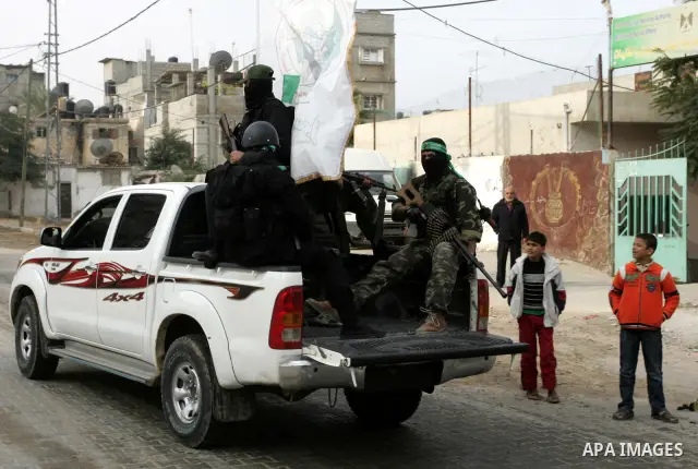 Palestinian Hamas militants patrol in the streets during the celebrations marking the Islamist movement's 24th founding anniversary, in the Rafah refugee camp in the southern Gaza Strip on December 14, 2011. Photo by Abe...