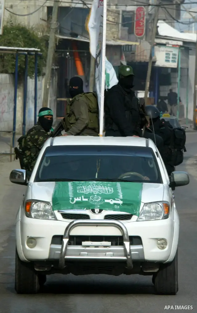 Palestinian Hamas militants patrol in the streets during the celebrations marking the Islamist movement's 24th founding anniversary, in the Rafah refugee camp in the southern Gaza Strip on December 14, 2011. Photo by Abe...