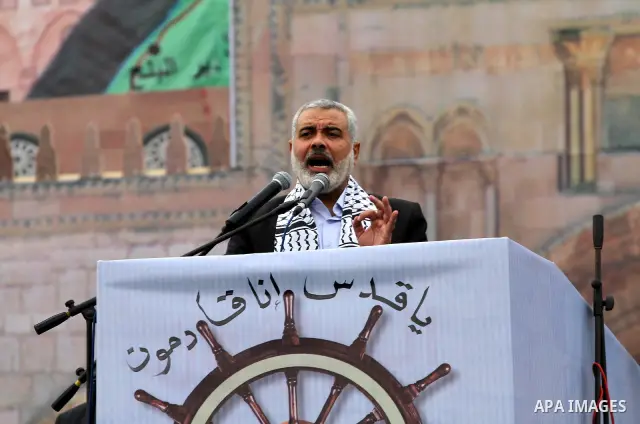 Palestinian prime minister in Gaza Strip, Ismail Haniya speaks to the Islamist Hamas movement's supporters as they gather in Gaza City to celebrate the 24th anniversary of its foundation on December 14, 2011. Photo by Mo...