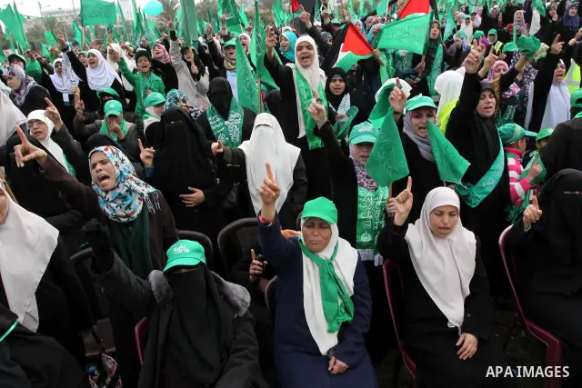 Thousands of Palestinian supporters of Hamas wave the Islamist movement's flags during celebrations for the 24th anniversary of its foundation in Gaza City on December 14, 2011. Photo by Mohammed Asad
