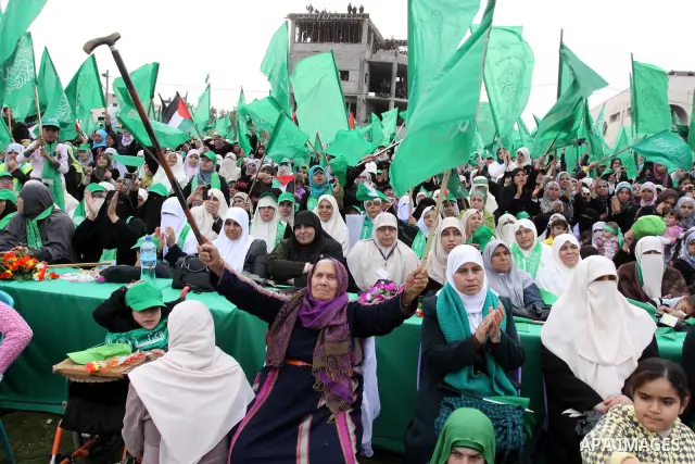 Thousands of Palestinian supporters of Hamas wave the Islamist movement's flags during celebrations for the 24th anniversary of its foundation in Gaza City on December 14, 2011. Photo by Mohammed Asad
