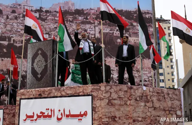 Palestinian prime minister in Gaza Strip, Ismail Haniya waves at the Islamist Hamas movement's supporters as they gather in Gaza City to celebrate the 24th anniversary of its foundation on December 14, 2011. Photo by Moh...