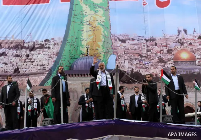 Palestinian prime minister in Gaza Strip, Ismail Haniya waves at the Islamist Hamas movement's supporters as they gather in Gaza City to celebrate the 24th anniversary of its foundation on December 14, 2011. Photo by Moh...