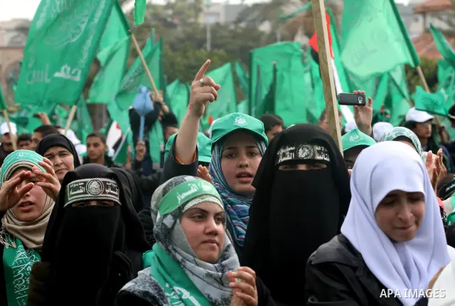 Thousands of Palestinian supporters of Hamas wave the Islamist movement's flags during celebrations for the 24th anniversary of its foundation in Gaza City on December 14, 2011. Photo by Mohammed Asad