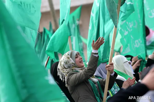 Thousands of Palestinian supporters of Hamas wave the Islamist movement's flags during celebrations for the 24th anniversary of its foundation in Gaza City on December 14, 2011. Photo by Mohammed Asad