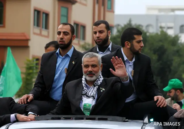 Palestinian prime minister in Gaza Strip, Ismail Haniya waves at the Islamist Hamas movement's supporters as they gather in Gaza City to celebrate the 24th anniversary of its foundation on December 14, 2011. Photo by Ash...