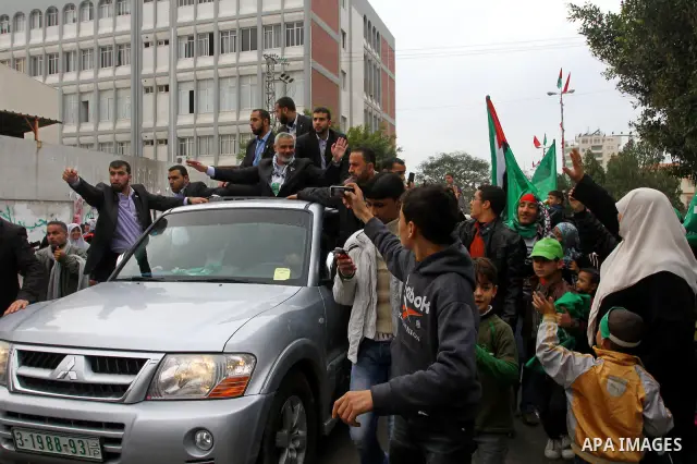Palestinian prime minister in Gaza Strip, Ismail Haniya waves at the Islamist Hamas movement's supporters as they gather in Gaza City to celebrate the 24th anniversary of its foundation on December 14, 2011. Photo by Ash...