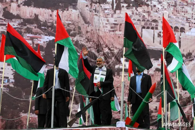 Palestinian prime minister in Gaza Strip, Ismail Haniya waves at the Islamist Hamas movement's supporters as they gather in Gaza City to celebrate the 24th anniversary of its foundation on December 14, 2011. Photo by Ash...