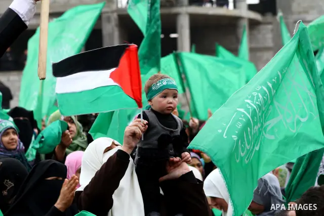 Thousands of Palestinian supporters of Hamas wave the Islamist movement's flags during celebrations for the 24th anniversary of its foundation in Gaza City on December 14, 2011. Photo by Ashraf Amra
