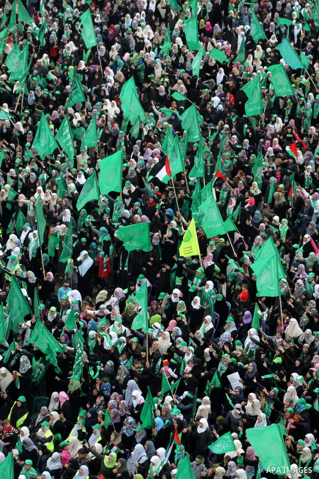 Thousands of Palestinian supporters of Hamas wave the Islamist movement's flags during celebrations for the 24th anniversary of its foundation in Gaza City on December 14, 2011. Photo by Ashraf Amra