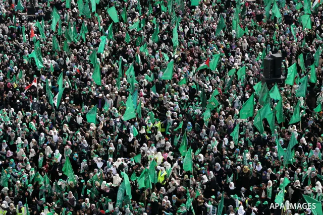 Thousands of Palestinian supporters of Hamas wave the Islamist movement's flags during celebrations for the 24th anniversary of its foundation in Gaza City on December 14, 2011. Photo by Ashraf Amra
