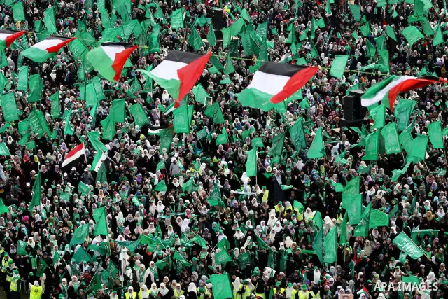 Thousands of Palestinian supporters of Hamas wave the Islamist movement's flags during celebrations for the 24th anniversary of its foundation in Gaza City on December 14, 2011. Photo by Ashraf Amra