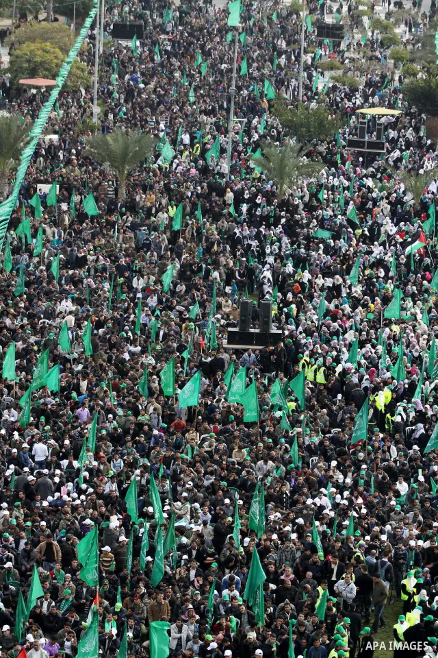 Thousands of Palestinian supporters of Hamas wave the Islamist movement's flags during celebrations for the 24th anniversary of its foundation in Gaza City on December 14, 2011. Photo by Ashraf Amra