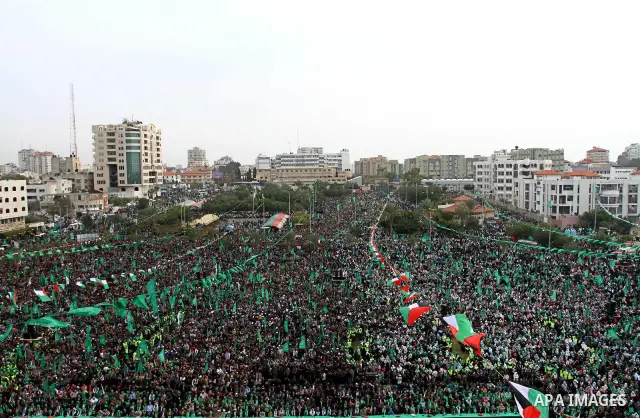 Thousands of Palestinian supporters of Hamas wave the Islamist movement's flags during celebrations for the 24th anniversary of its foundation in Gaza City on December 14, 2011. Photo by Ashraf Amra