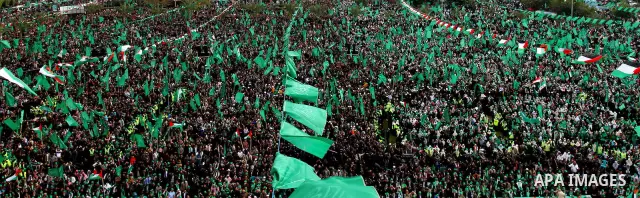 Thousands of Palestinian supporters of Hamas wave the Islamist movement's flags during celebrations for the 24th anniversary of its foundation in Gaza City on December 14, 2011. Photo by Ashraf Amra