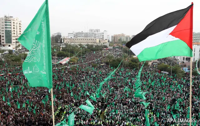 Thousands of Palestinian supporters of Hamas wave the Islamist movement's flags during celebrations for the 24th anniversary of its foundation in Gaza City on December 14, 2011. Photo by Ashraf Amra