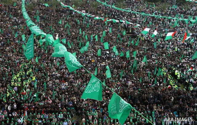 Thousands of Palestinian supporters of Hamas wave the Islamist movement's flags during celebrations for the 24th anniversary of its foundation in Gaza City on December 14, 2011. Photo by Ashraf Amra