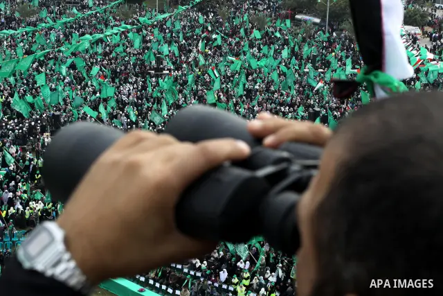 Thousands of Palestinian supporters of Hamas wave the Islamist movement's flags during celebrations for the 24th anniversary of its foundation in Gaza City on December 14, 2011. Photo by Ashraf Amra