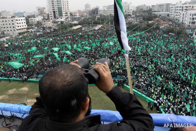 Thousands of Palestinian supporters of Hamas wave the Islamist movement's flags during celebrations for the 24th anniversary of its foundation in Gaza City on December 14, 2011. Photo by Ashraf Amra