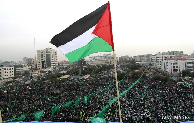 Thousands of Palestinian supporters of Hamas wave the Islamist movement's flags during celebrations for the 24th anniversary of its foundation in Gaza City on December 14, 2011. Photo by Ashraf Amra