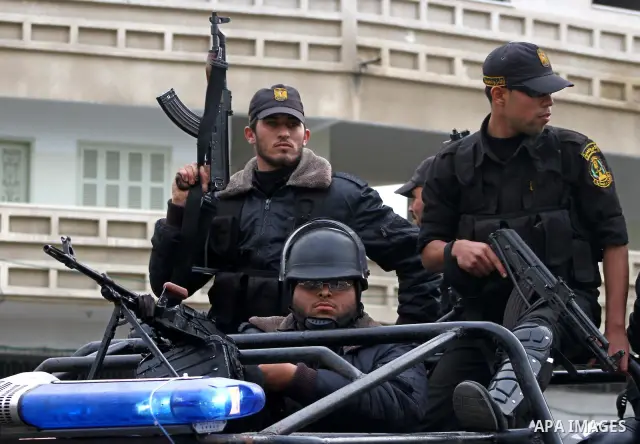 Policemen guard as thousands of Palestinian supporters of Hamas wave the Islamist movement's flags during celebrations for the 24th anniversary of its foundation in Gaza City on December 14, 2011. Photo by Ashraf Amra
