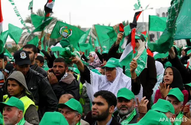 Thousands of Palestinian supporters of Hamas wave the Islamist movement's flags during celebrations for the 24th anniversary of its foundation in Gaza City on December 14, 2011. Photo by Ashraf Amra