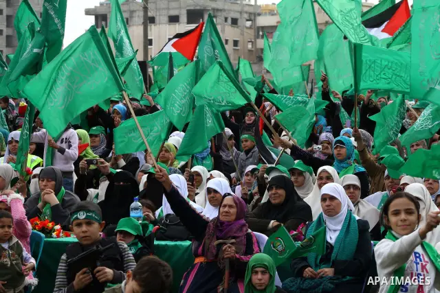 Thousands of Palestinian supporters of Hamas wave the Islamist movement's flags during celebrations for the 24th anniversary of its foundation in Gaza City on December 14, 2011. Photo by Ashraf Amra
