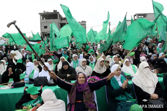 Thousands of Palestinian supporters of Hamas wave the Islamist movement's flags during celebrations for the 24th anniversary of its foundation in Gaza City on December 14, 2011. Photo by Ashraf Amra