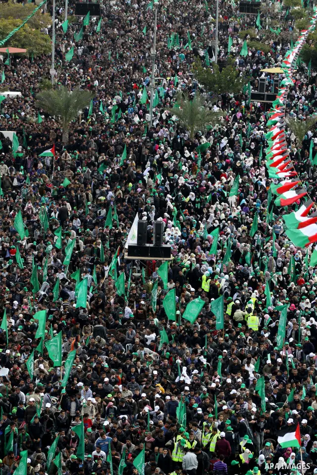 Thousands of Palestinian supporters of Hamas wave the Islamist movement's flags during celebrations for the 24th anniversary of its foundation in Gaza City on December 14, 2011. Photo by Ashraf Amra
