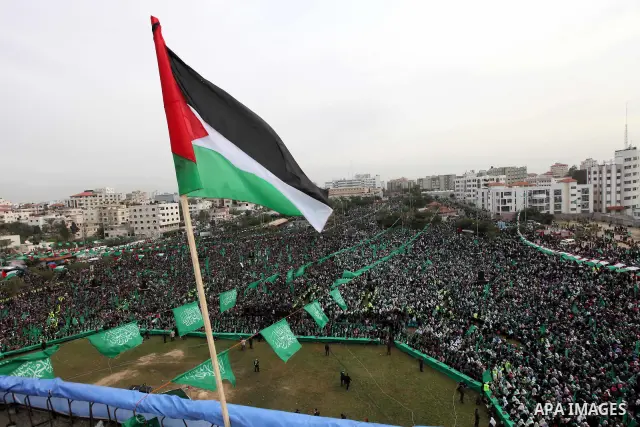 Thousands of Palestinian supporters of Hamas wave the Islamist movement's flags during celebrations for the 24th anniversary of its foundation in Gaza City on December 14, 2011. Photo by Ashraf Amra