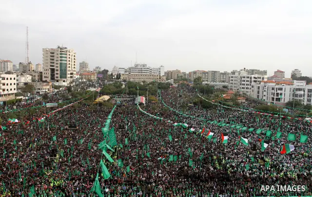 Thousands of Palestinian supporters of Hamas wave the Islamist movement's flags during celebrations for the 24th anniversary of its foundation in Gaza City on December 14, 2011. Photo by Ashraf Amra