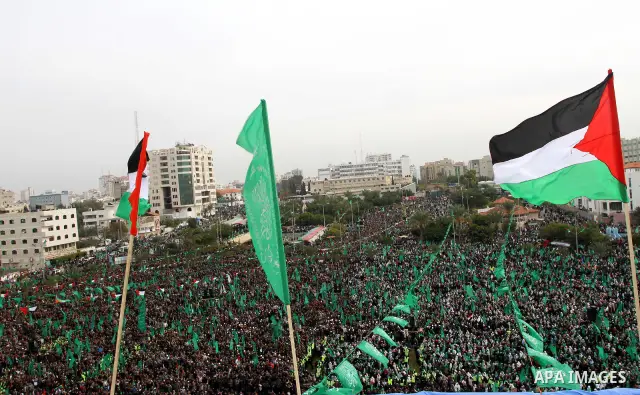 Thousands of Palestinian supporters of Hamas wave the Islamist movement's flags during celebrations for the 24th anniversary of its foundation in Gaza City on December 14, 2011. Photo by Ashraf Amra