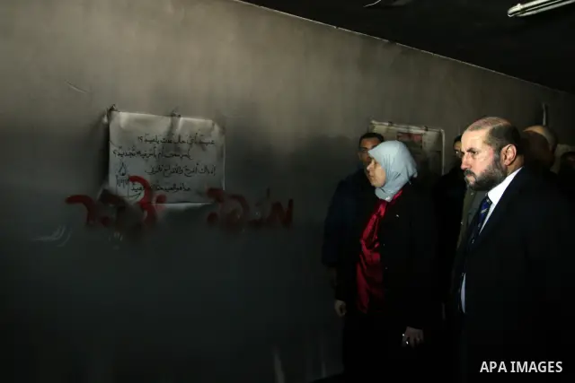 Palestinian women from the West bank village of Burqa near Ramallah, view the damage at the village Al-Nur mosque, on 15 December 2011. The mosque was set on fire during the night allegedly by Israeli settlers and Hebrew...
