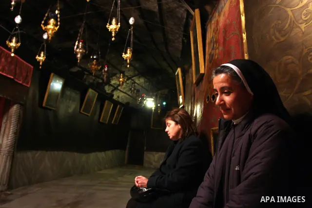 A nun prays at the Grotto of the Church of the Nativity, the traditional birthplace of Jesus Christ, in the West Bank city of Bethlehem December 15, 2011, ahead of Christmas. Christian worshippers began their spiritual p...