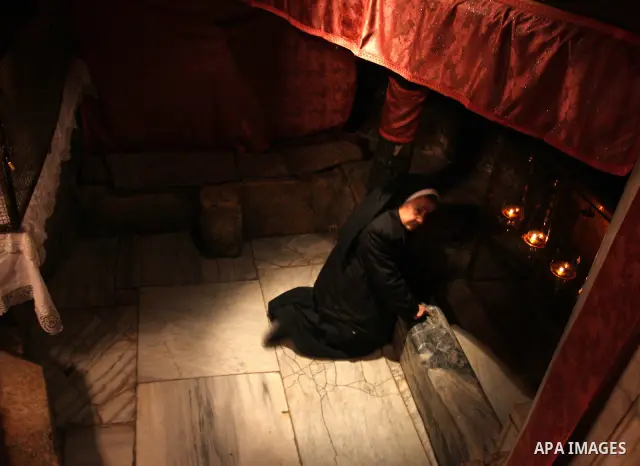 A nun prays at the Grotto of the Church of the Nativity, the traditional birthplace of Jesus Christ, in the West Bank city of Bethlehem December 15, 2011, ahead of Christmas. Christian worshippers began their spiritual p...